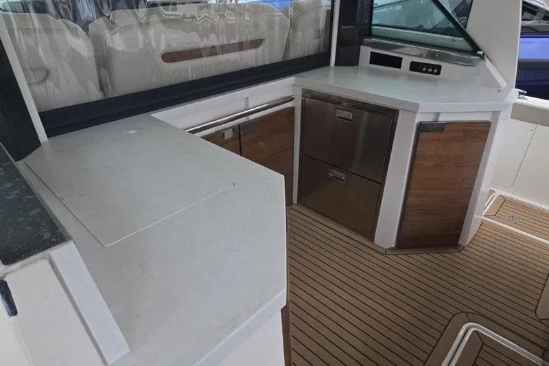 Yacht Photos Pics 2023 Tiara Yachts 48 LS interior with modern kitchen and wood flooring.