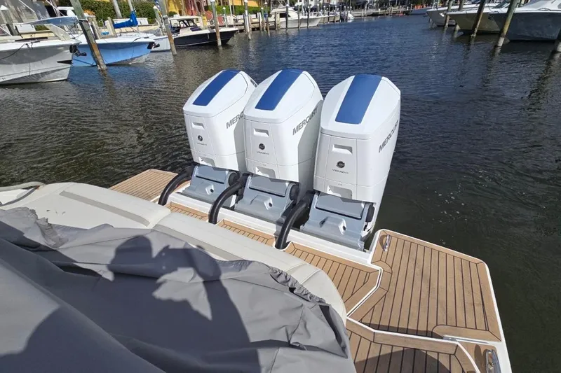  Yacht Photos Pics 2023 Tiara Yachts 48 LS with triple Mercury outboard engines docked at marina.
