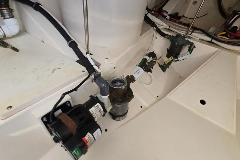  Yacht Photos Pics Engine compartment of 2023 Tiara Yachts 48 LS, showcasing mechanical components and wiring.