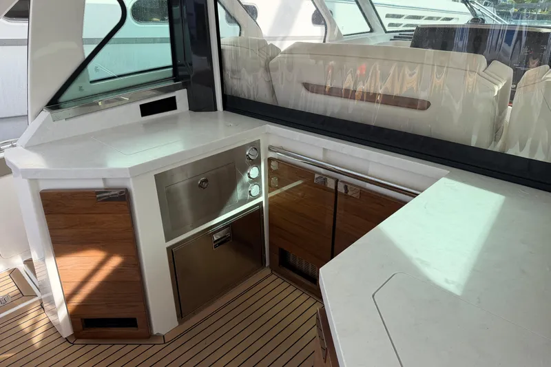  Yacht Photos Pics 2023 Tiara Yachts 48 LS interior with modern kitchen and seating area.