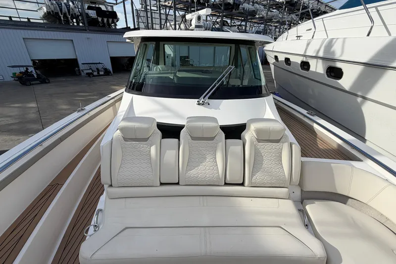  Yacht Photos Pics 2023 Tiara Yachts 48 LS luxury boat with plush seating and sleek design.
