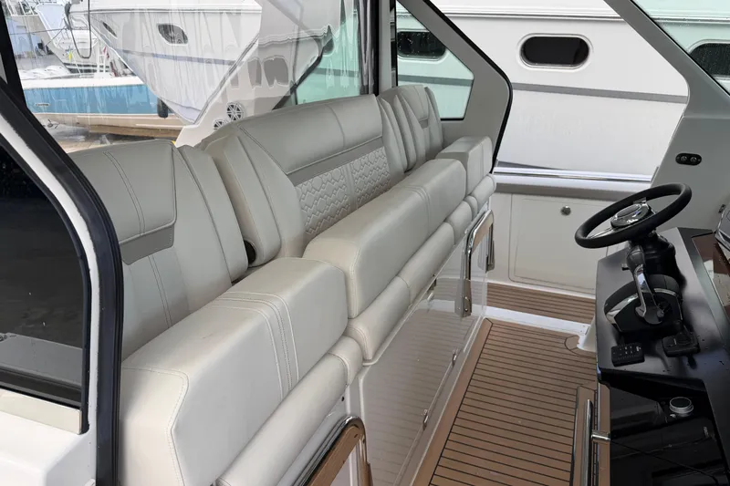  Yacht Photos Pics Luxurious interior of 2023 Tiara Yachts 48 LS with plush seating and modern helm.