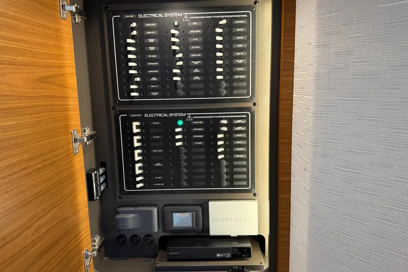  Yacht Photos Pics Electrical panel inside 2023 Tiara Yachts 48 LS, showcasing circuit breakers and controls.