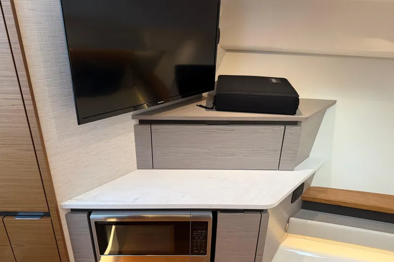  Yacht Photos Pics 2023 Tiara Yachts 48 LS interior with TV, microwave, and modern cabinetry.