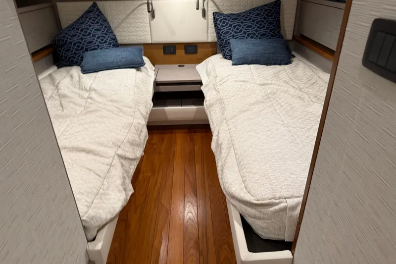  Yacht Photos Pics 2023 Tiara Yachts 48 LS cabin with twin beds and wooden flooring.