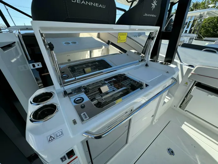  Yacht Photos Pics 2024 Jeanneau 9.0 Walk boat interior with open grill and cup holders.