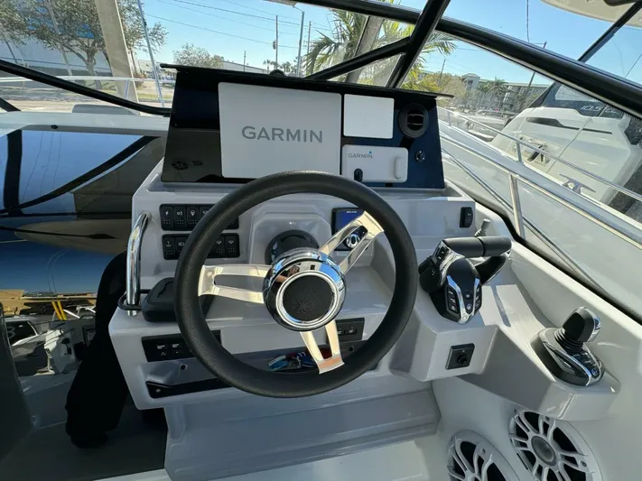  Yacht Photos Pics 2024 Jeanneau 9.0 Walk helm with Garmin navigation, steering wheel, and control panel.