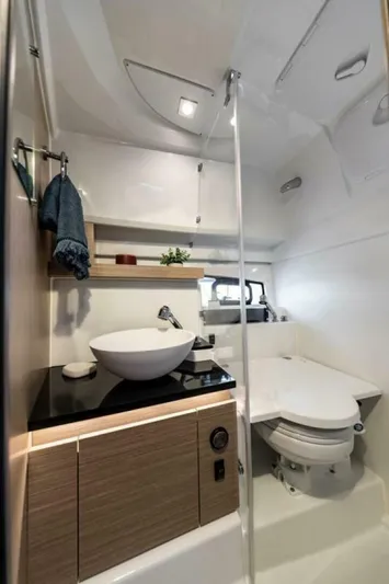  Yacht Photos Pics 2024 Jeanneau 9.0 Walk bathroom with modern sink, toilet, and sleek design.