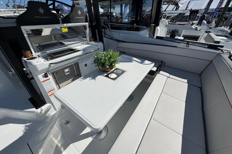  Yacht Photos Pics 2024 Jeanneau Leader 9.0 WA Series 2 boat interior with seating and dining area.