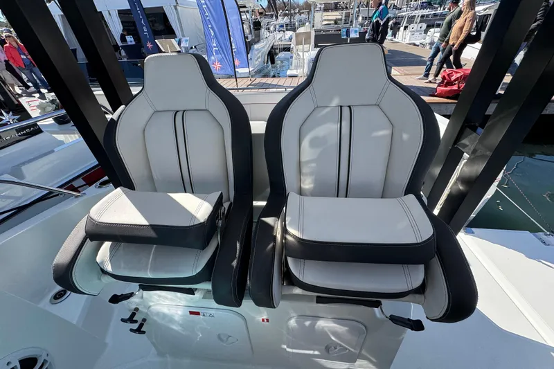  Yacht Photos Pics 2024 Jeanneau Leader 9.0 WA Series 2 boat seats, white and black, at a marina.