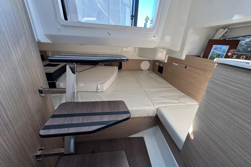  Yacht Photos Pics 2024 Jeanneau Leader 9.0 WA Series 2 cabin interior with wooden steps and cozy sleeping area.