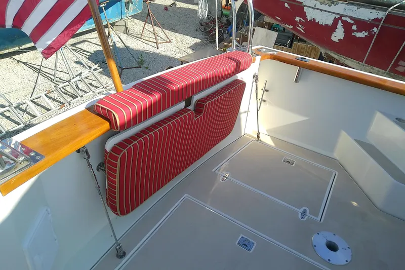 Kathrine E. Yacht Photos Pics 2002 Sabreline 36 Express boat interior with striped red cushions and wooden accents.