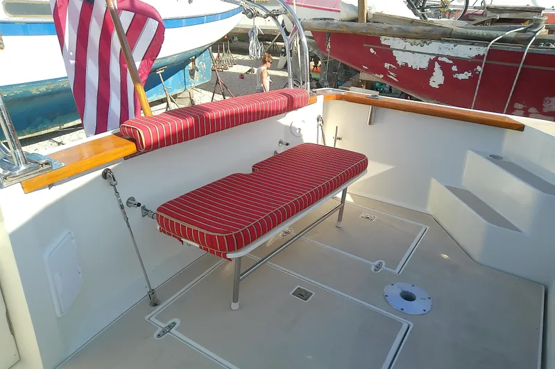 Kathrine E. Yacht Photos Pics 2002 Sabreline 36 Express boat deck with striped seating and American flag.