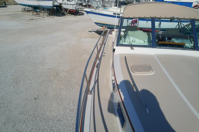 Kathrine E. Yacht Photos Pics 2002 Sabreline 36 Express boat on dry dock, surrounded by other vessels.