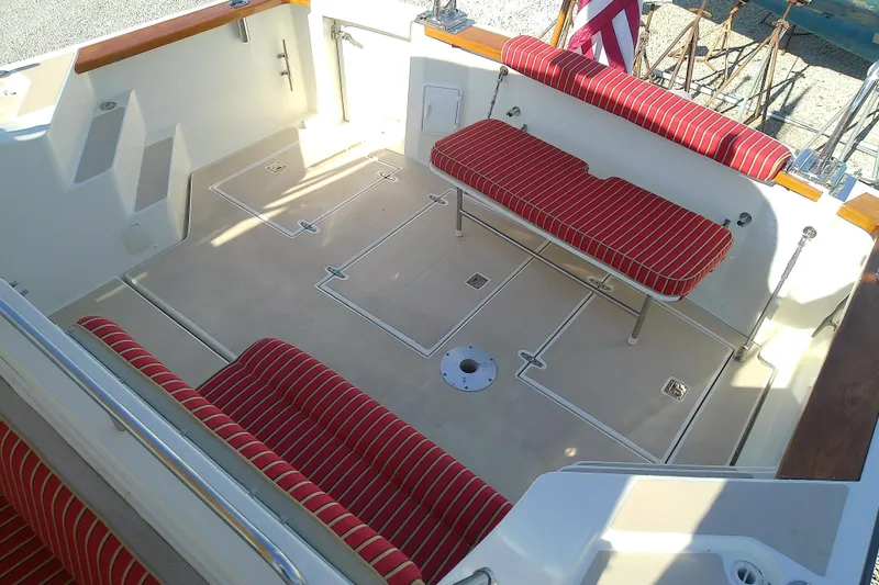 Kathrine E. Yacht Photos Pics 2002 Sabreline 36 Express boat interior with red-striped seating and spacious deck.