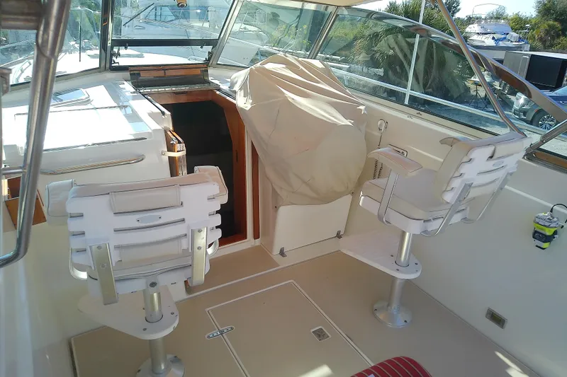Kathrine E. Yacht Photos Pics 2002 Sabreline 36 Express boat interior with helm chairs and covered console.