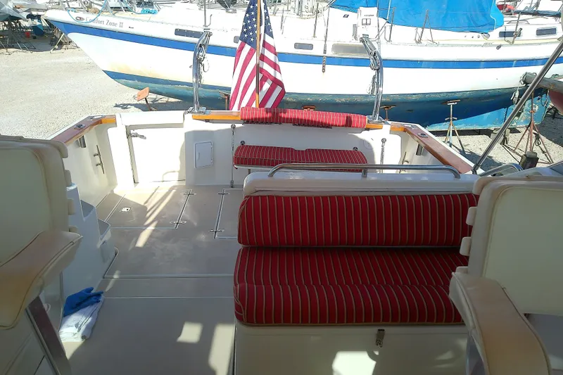 Kathrine E. Yacht Photos Pics 2002 Sabreline 36 Express boat interior with red-striped seating and American flag.