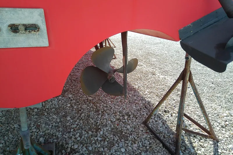 Kathrine E. Yacht Photos Pics Propeller of 2002 Sabreline 36 Express boat on gravel, supported by stands.