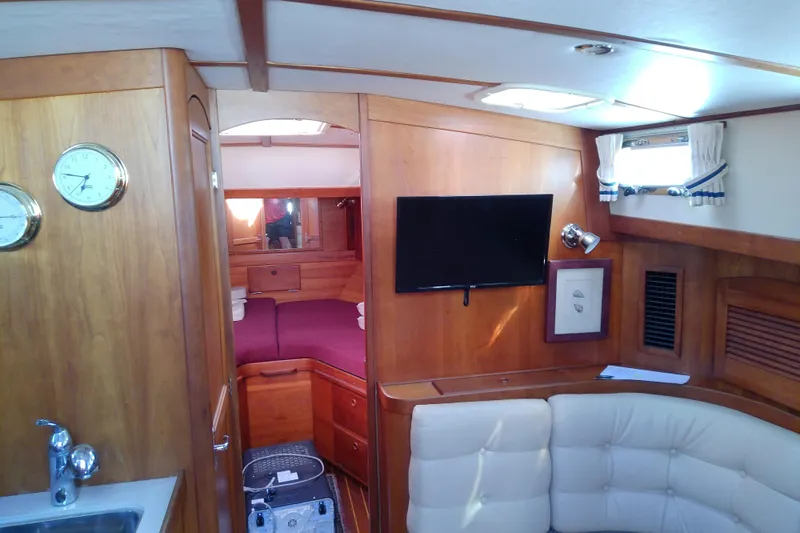 Kathrine E. Yacht Photos Pics Interior of 2002 Sabreline 36 Express yacht with wood finish and cozy seating area.
