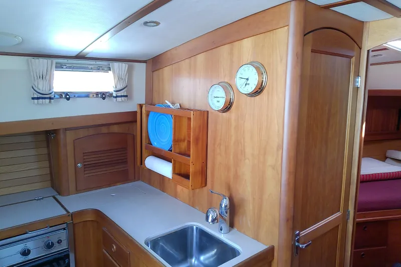 Kathrine E. Yacht Photos Pics Interior of 2002 Sabreline 36 Express yacht with wooden cabinetry and compact kitchen.