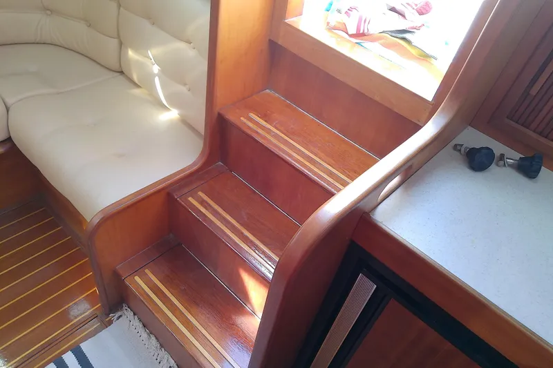 Kathrine E. Yacht Photos Pics Interior of 2002 Sabreline 36 Express with wooden stairs and cushioned seating.