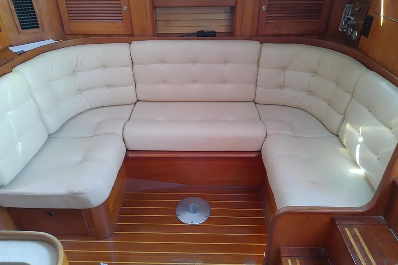 Kathrine E. Yacht Photos Pics Luxurious seating area on 2002 Sabreline 36 Express yacht with cream cushions and wooden accents.