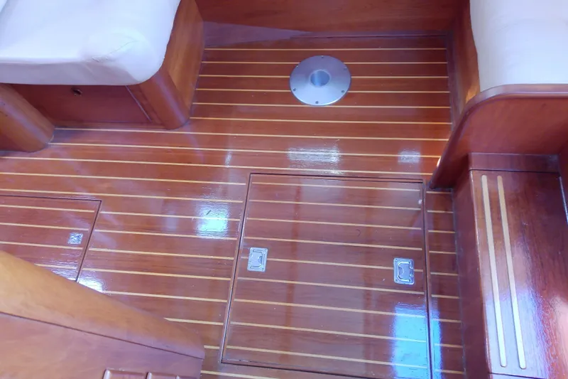 Kathrine E. Yacht Photos Pics Polished wooden floor of 2002 Sabreline 36 Express boat interior with storage compartments.