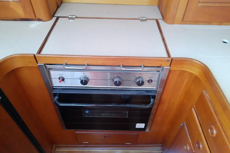 Kathrine E. Yacht Photos Pics 2002 Sabreline 36 Express yacht kitchen with built-in oven and wooden cabinetry.