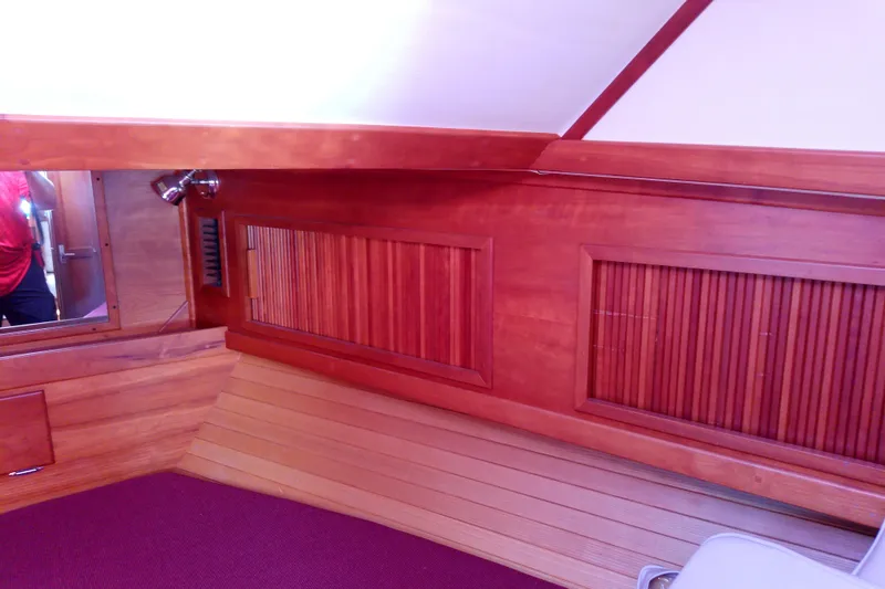 Kathrine E. Yacht Photos Pics Interior of 2002 Sabreline 36 Express with wooden paneling and red carpet.