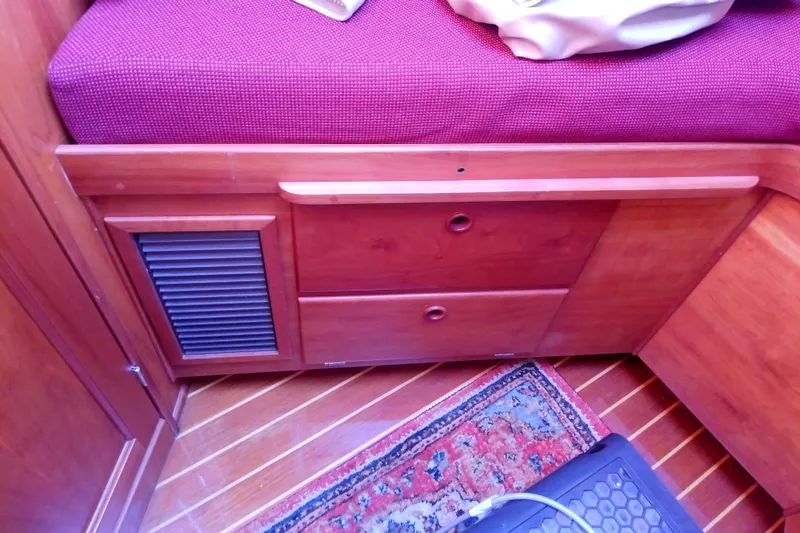Kathrine E. Yacht Photos Pics Interior of 2002 Sabreline 36 Express with wooden cabinetry and red upholstery.