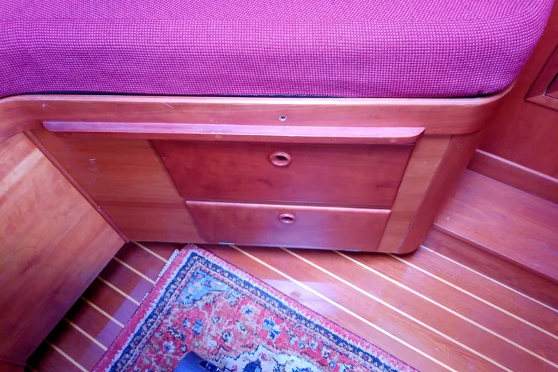 Kathrine E. Yacht Photos Pics Interior of 2002 Sabreline 36 Express with wooden drawers and red upholstery.