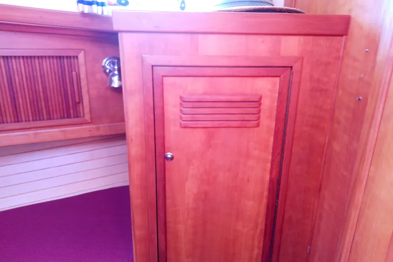 Kathrine E. Yacht Photos Pics Wooden interior of 2002 Sabreline 36 Express boat, featuring cabinetry and paneling.