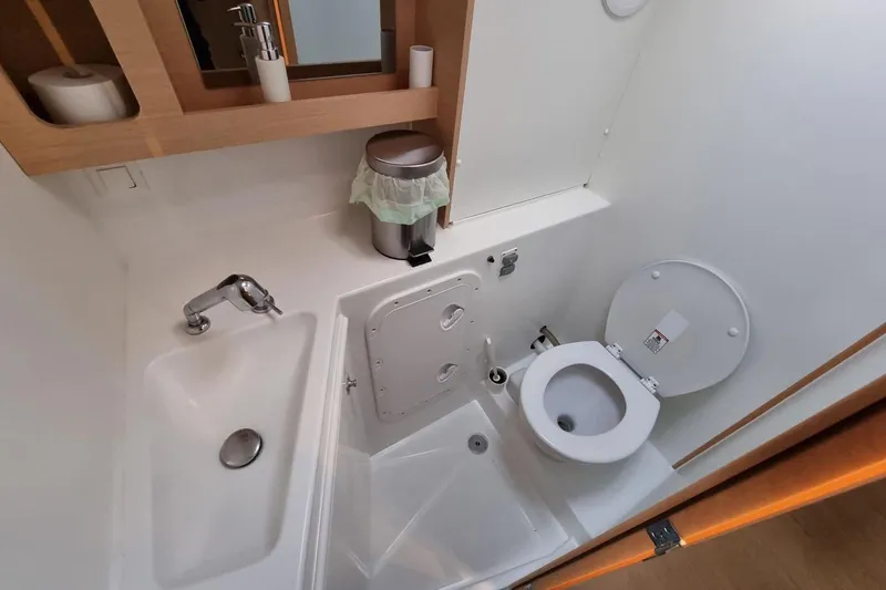  Yacht Photos Pics Bathroom interior of 2017 Lagoon 42 yacht with sink, toilet, and mirror cabinet.