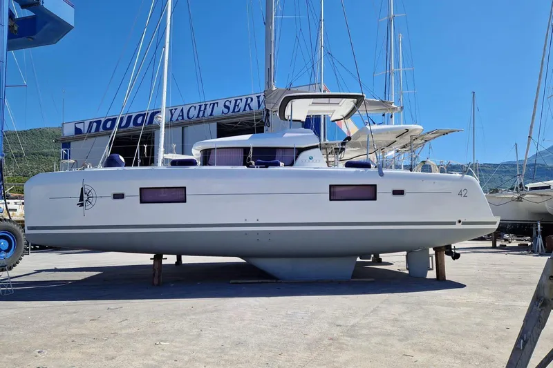  Yacht Photos Pics 2017 Lagoon 42 catamaran in a yacht service area, side view.