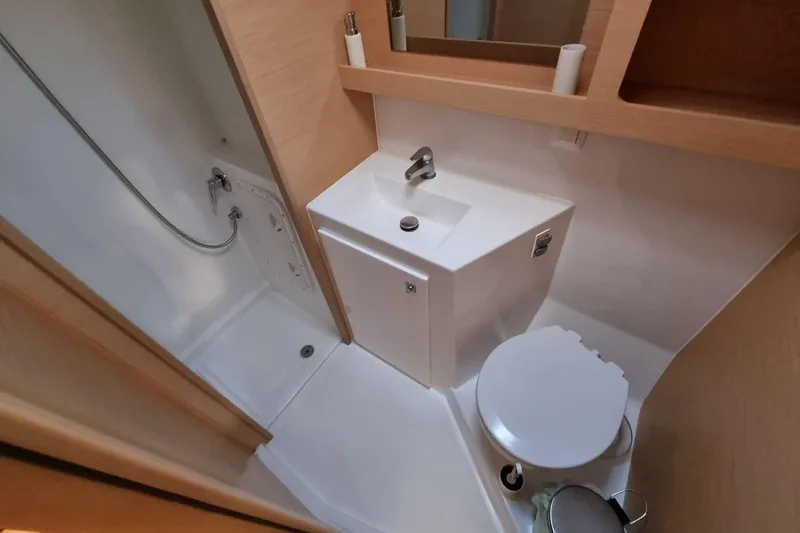  Yacht Photos Pics Compact bathroom in 2017 Lagoon 42 yacht with shower, sink, and toilet.