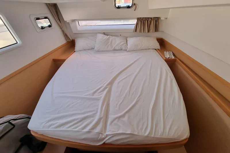  Yacht Photos Pics Cozy cabin interior of 2017 Lagoon 42 catamaran with comfortable bed and windows.