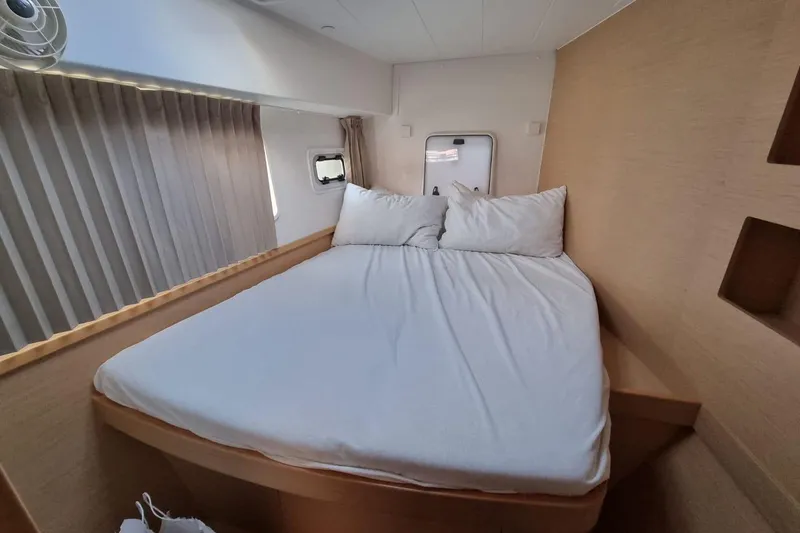  Yacht Photos Pics Cozy bedroom interior of 2017 Lagoon 42 catamaran with comfortable bed and natural light.
