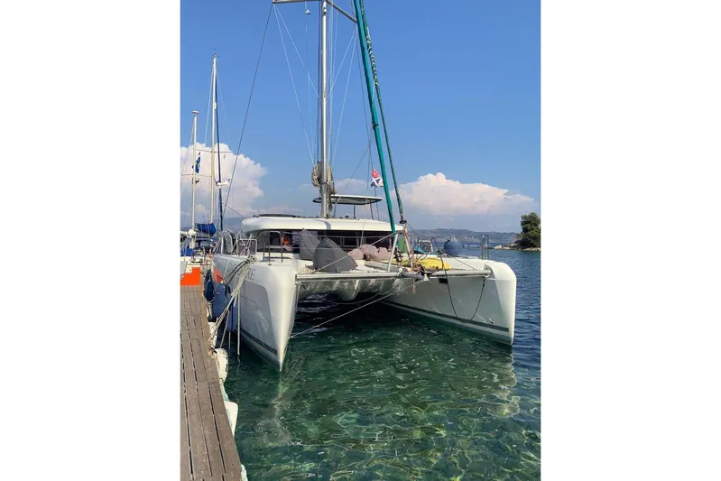  Yacht Photos Pics 2017 Lagoon 42 catamaran docked in clear waters, sunny day.