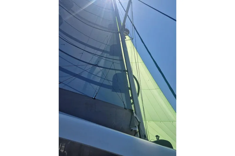  Yacht Photos Pics Sailing yacht Lagoon 42, 2017 model, with sunlit sails against a clear blue sky.