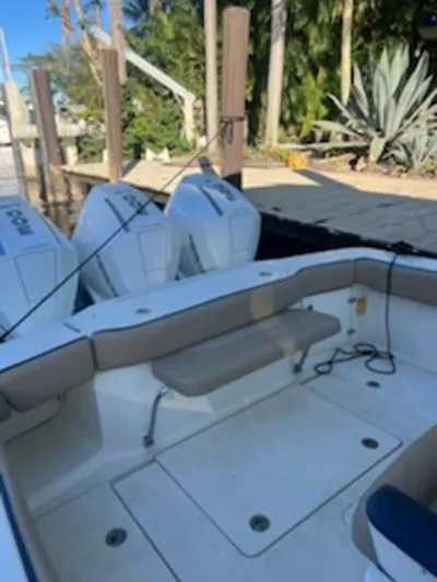 Mambo #5 Yacht Photos Pics 2017 Scout LXF 350 boat with dual engines docked near lush greenery.