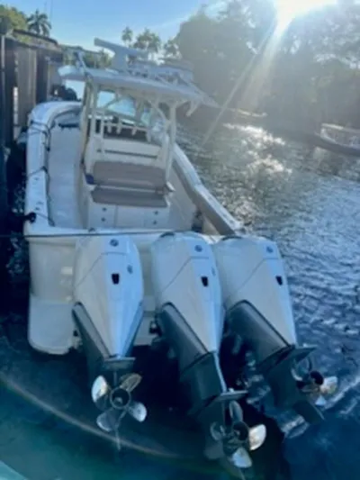 Mambo #5 Yacht Photos Pics 2017 Scout LXF 350 boat with triple outboard engines docked in sunny waters.