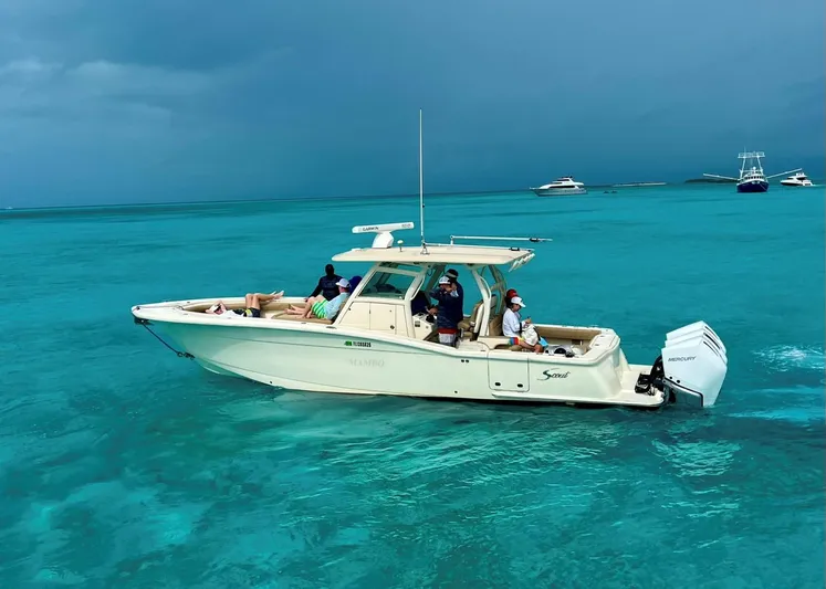 Mambo #5 Yacht Photos Pics 2017 Scout LXF 350 boat cruising on clear turquoise waters.