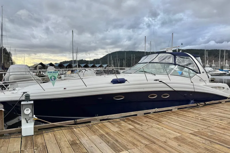  Yacht Photos Pics 2004 Sea Ray 420 Sundancer yacht docked, for sale, under cloudy sky.