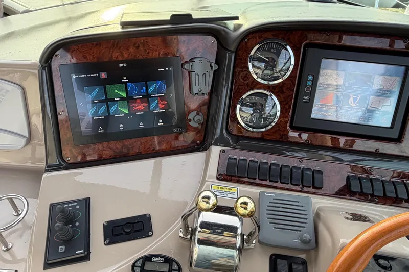  Yacht Photos Pics Control panel of a 2004 Sea Ray 420 Sundancer yacht with navigation screens.