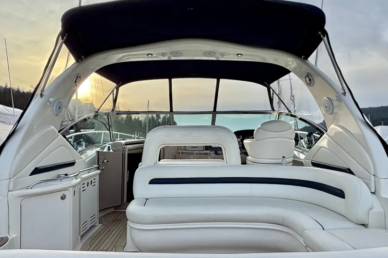  Yacht Photos Pics 2004 Sea Ray 420 Sundancer yacht interior with white seating and canopy at sunset.