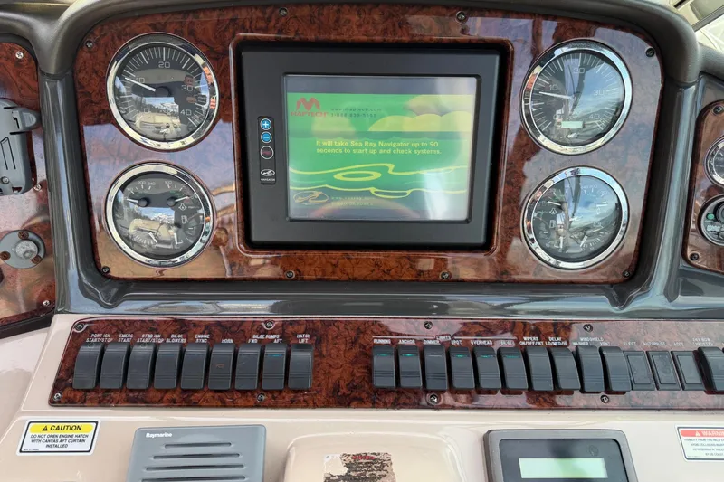  Yacht Photos Pics Dashboard of a 2004 Sea Ray 420 Sundancer with gauges and navigation screen.