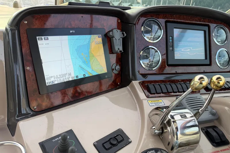  Yacht Photos Pics Control panel of a 2004 Sea Ray 420 Sundancer with navigation screens and gauges.