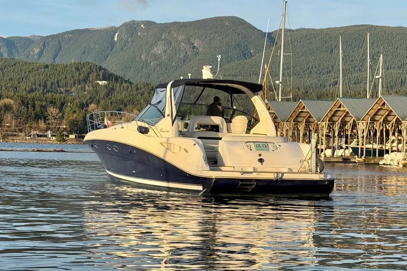  Yacht Photos Pics 2004 Sea Ray 420 Sundancer yacht on calm water with scenic mountain backdrop.