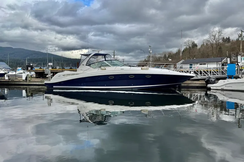  Yacht Photos Pics 2004 Sea Ray 420 Sundancer yacht docked at marina under cloudy sky.