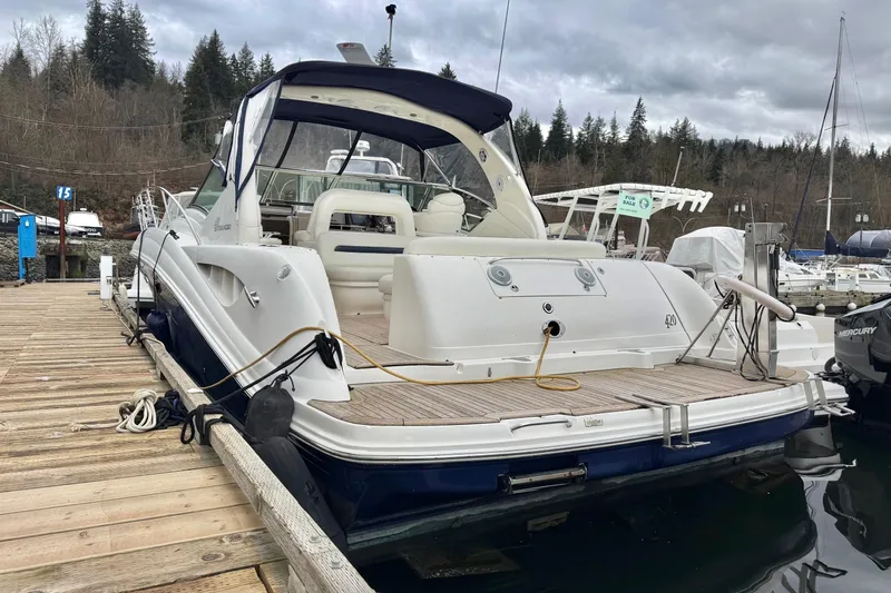  Yacht Photos Pics 2004 Sea Ray 420 Sundancer docked at marina with overcast sky.